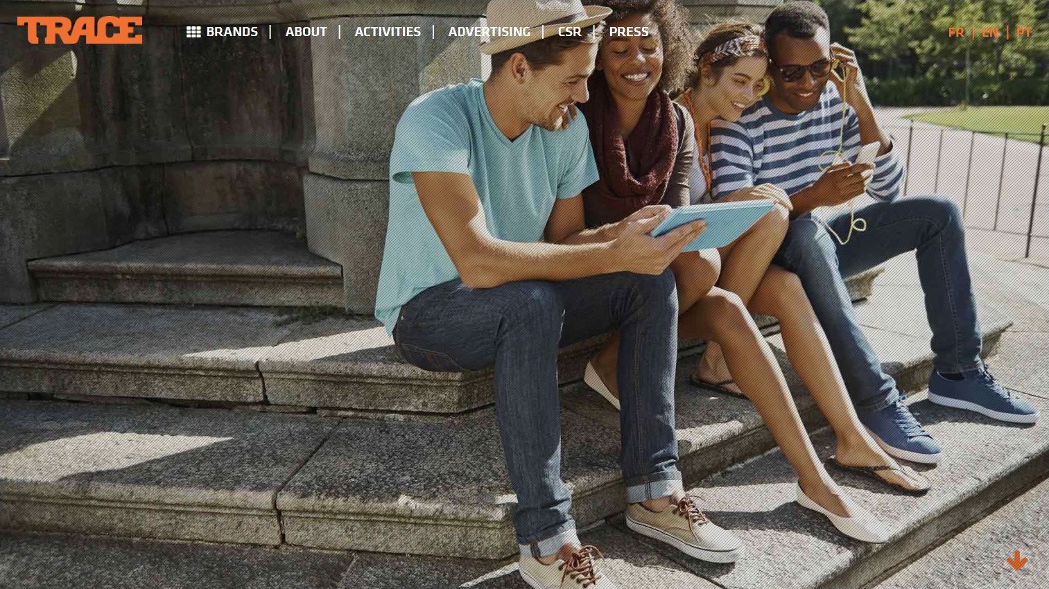 Quatre personnes assises sur des marches, regardant un écran.